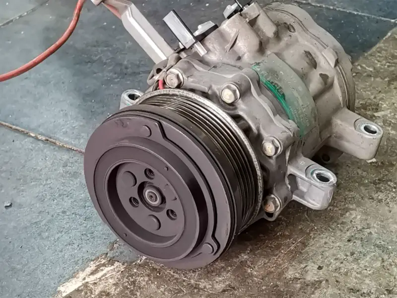 A car's AC compressor, a key component for cool air. Considering the ac compressor replacement cost? This part is vital for your comfort.