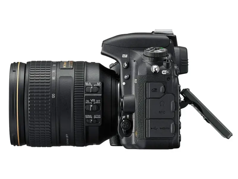 Nikon D750 test: aparat z obiektywem 24-120 mm, widoczne przyciski sterowania, Wi-Fi, HDMI i wejście mikrofonowe.