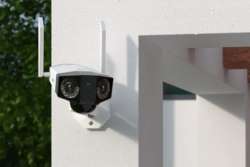 Kamera monitoringu z dwoma obiektywami zamontowana na białej ścianie.