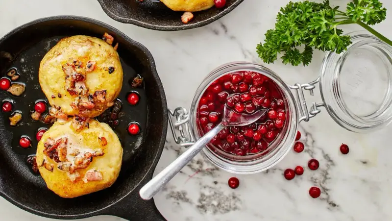 Kroppkakor recept: Gyllene kroppkakor i gjutjärnspanna med knaperstekt fläsk och lingonsylt. En klassisk svensk rätt.