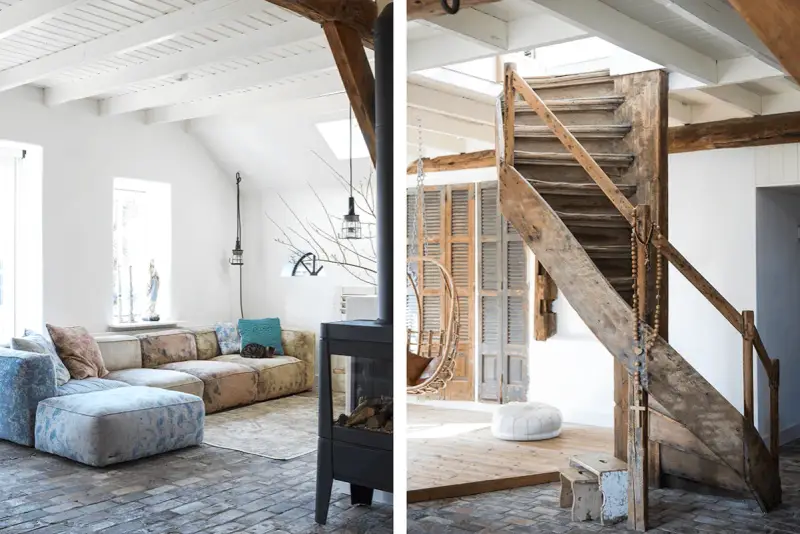 Ambiance chaleureuse dans cet **intérieur ferme rénovée moderne**. Canapé modulable, poêle design et escalier rustique en bois.