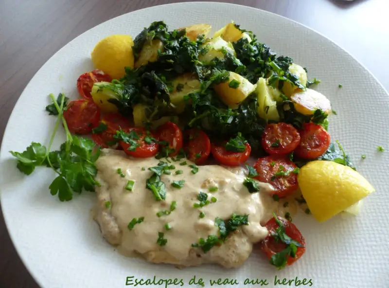 Escalope de veau crémeuse, accompagnée de pommes de terre sautées, tomates cerises rôties et quartiers de citron.