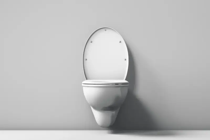 Biała, wisząca miska WC z klapą z duroplastu, zamontowana na szarej ścianie.