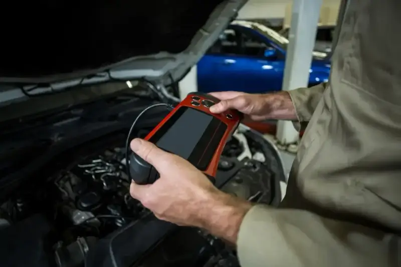 Mechanik używa skanera diagnostycznego do sprawdzenia stanu silnika. To ważne, by mieć aktualne papiery od gazu do przeglądu.