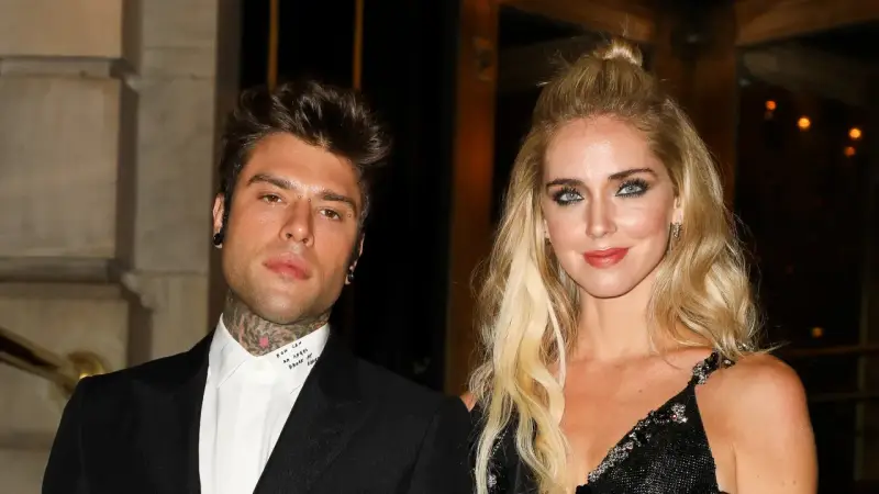 Chiara Ferragni i Fedez pozują do zdjęcia. Ona ma blond włosy upięte w kok, a on tatuaże na szyi.