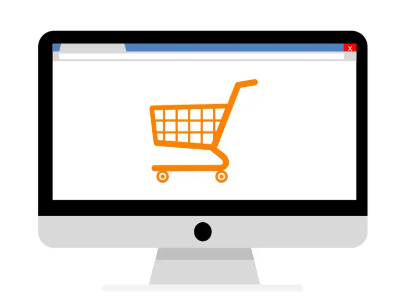 Monitor z ikoną koszyka zakupowego, symbolizujący branżę e-commerce i zakupy online.