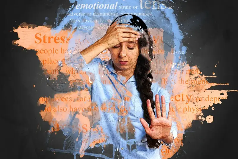 Kobieta z ręką na czole, otoczona słowami "stress", "emotional strain", "anxiety", "depression". Może to symbolizować niedobór witaminy B12 - objawy psychiczne.