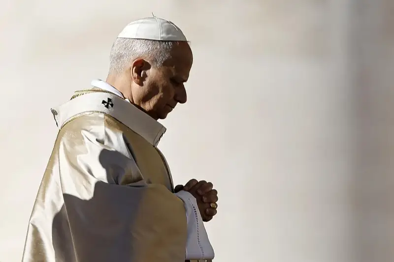 Papież w białej piusce i złotej szacie modli się, wierzę w boga. W jego oczach widać głęboką wiarę.