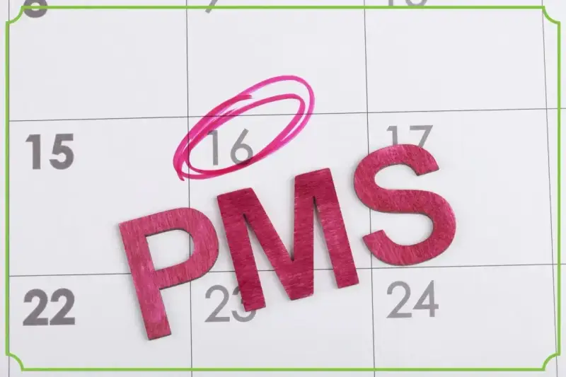 Litery PMS na kalendarzu. Dzień 16 zaznaczony kółkiem, sugerując fałszywe objawy ciąży.