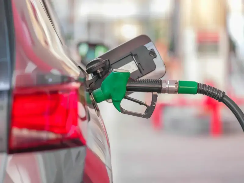 Tankowanie Kia Ceed 1.6 benzyna. Zielony pistolet paliwowy wlewa paliwo do baku.