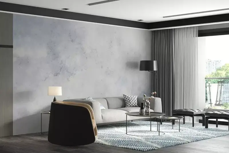 Nowoczesny salon z sofą, stolikami i dywanem. Ściana za sofą ma subtelny **efekt betonu**, nadając wnętrzu industrialny charakter.