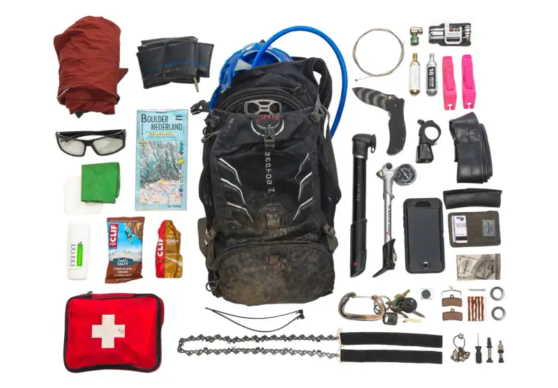 Essential mtb must haves for any adventure: backpack, pump, tools, spare tube, first aid, map, and snacks.