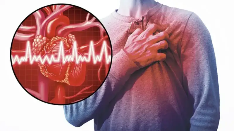 Człowiek trzymający się za klatkę piersiową, symbolizujący dusznicę bolesną. Obok grafika serca z zapisem EKG.