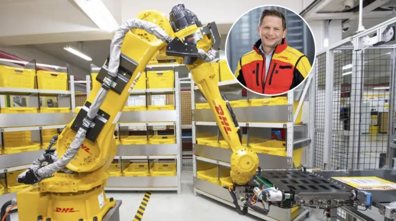 Zautomatyzowany magazyn DHL, duża giełda niemiecka, z robotem i uśmiechniętym menedżerem.