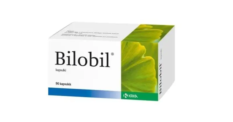 Opakowanie leku Bilobil w kapsułkach, z zielonym liściem miłorzębu.