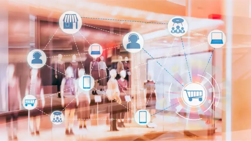 Icone di un negozio, carrello, cuffie e dispositivi connessi in una vetrina, che illustrano il retail significato.