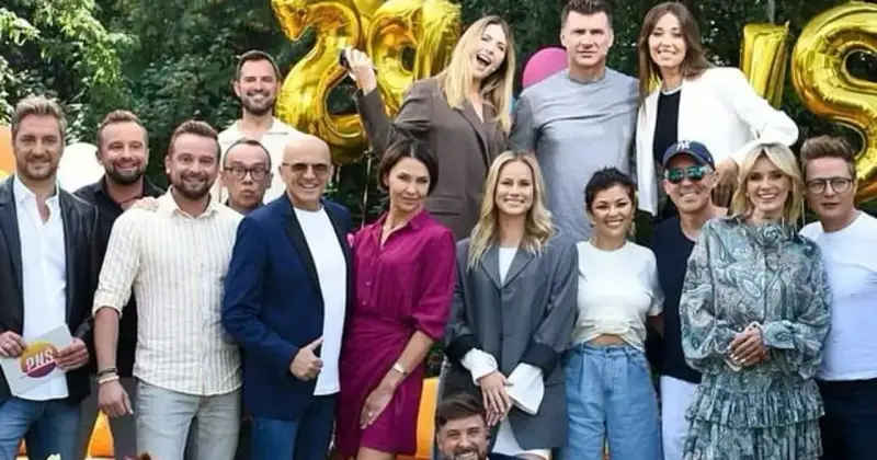 Ekipa TVP2 Pytanie na śniadanie dzisiejszy odcinek świętuje 28 lat! Radosna grupa prezenterów i gości pozuje do wspólnego zdjęcia na tle złotych balonów.