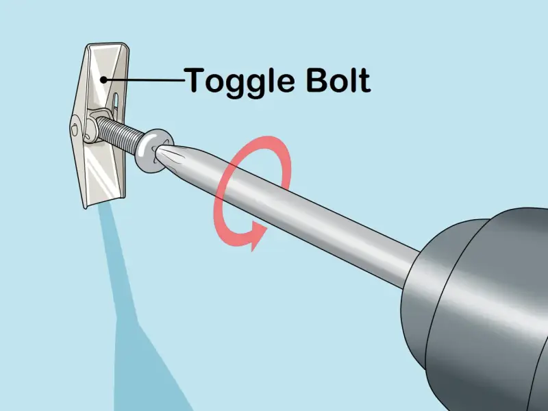 Utilisation d'un boulon à bascule pour accrocher un miroir au mur. La vis est insérée dans le mur et le mécanisme à bascule s'ouvre derrière la cloison sèche.