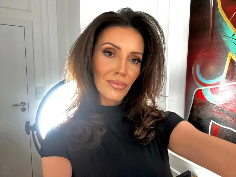 Dominika Serowska, wiek nieznany, pozuje do selfie w czarnej bluzce. W tle widać drzwi, lampę i abstrakcyjny obraz.
