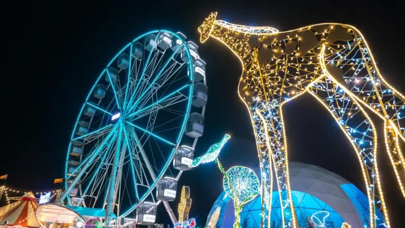 Leuchtende Giraffe und Riesenrad auf einem Jahrmarkt, perfekt für Winterferien Thüringen 2026.