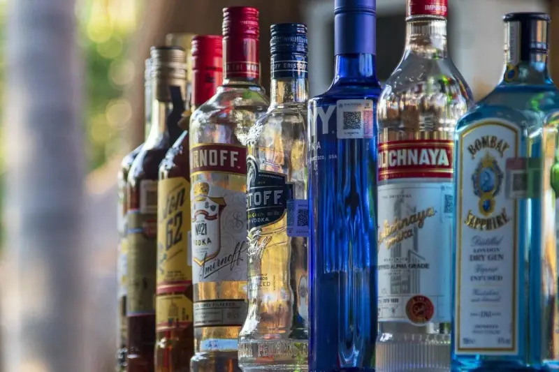 Rząd butelek alkoholu, w tym Smirnoff i Bombay Sapphire, sugeruje ceny alkoholu na Cyprze.