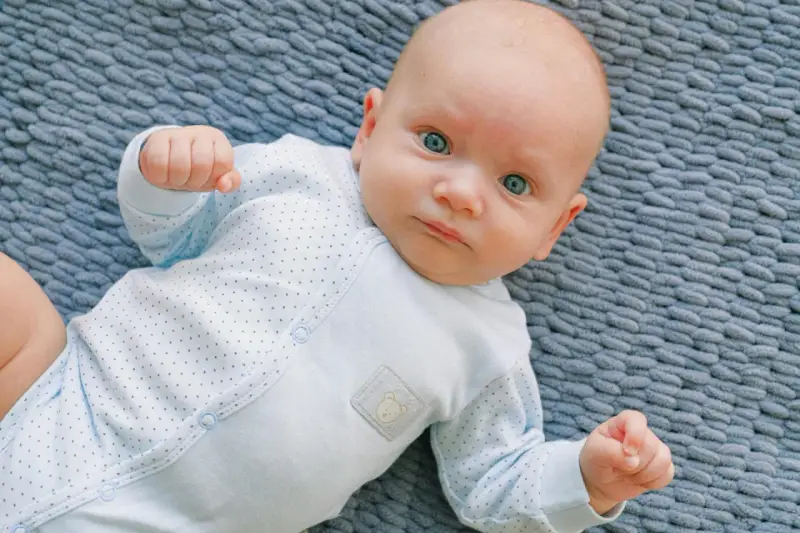 Niebieskie oczy niemowlaka patrzą wprost. Cudowny widok, kiedy dziecko przesypia noc.