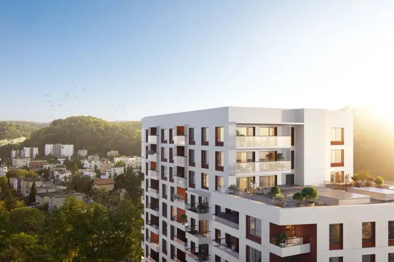 Nowe inwestycje Gdynia: nowoczesny apartamentowiec z tarasami i widokiem na zieleń.