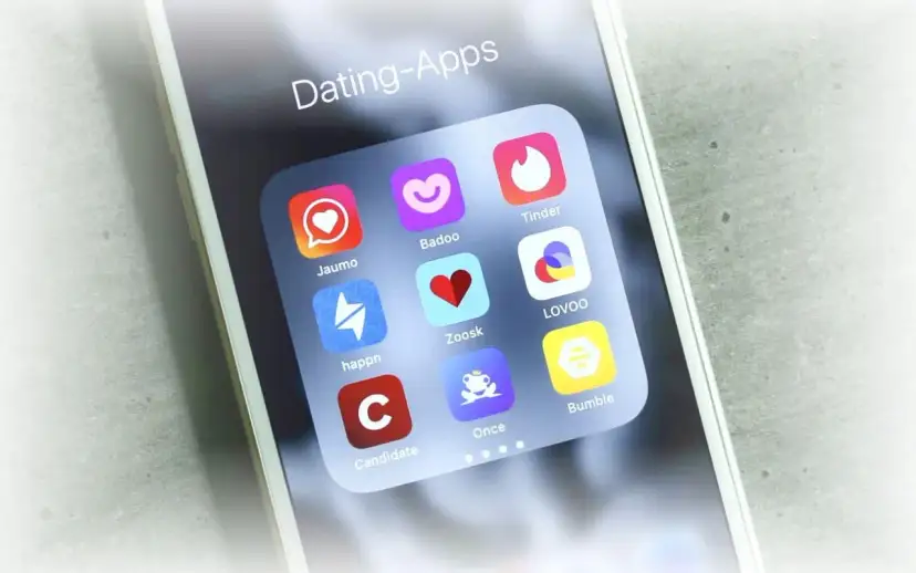 Smartphone-Bildschirm mit Icons verschiedener Dating-Apps wie Tinder, Badoo und Lovoo.