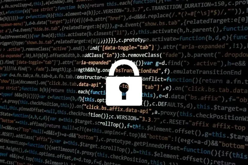 Zapomniałem hasła do laptopa. Widzę kod i ikonę kłódki, symbolizującą bezpieczeństwo i potencjalne problemy z dostępem.