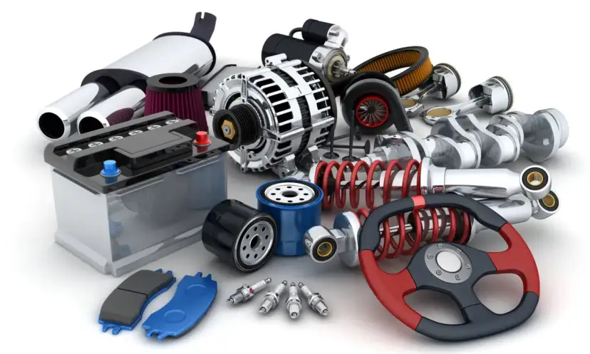 Gros plan sur un assortiment de pièces automobiles : batterie, filtres, bougies, amortisseurs, volant, etc.