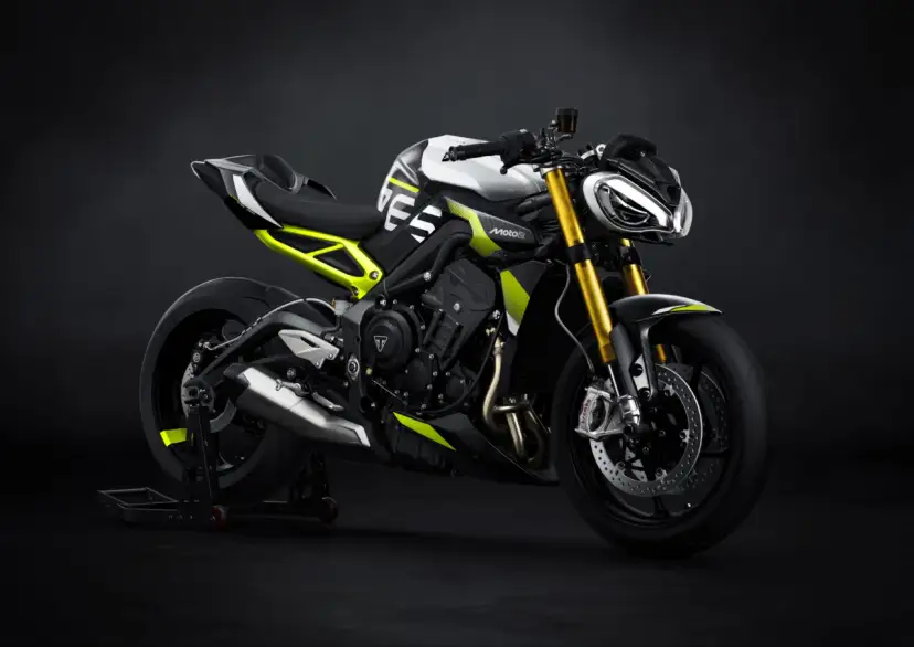 Nowoczesny motocykl Triumph Street Triple w białym i czarnym malowaniu z neonowo-żółtymi akcentami, gotowy do drogi.