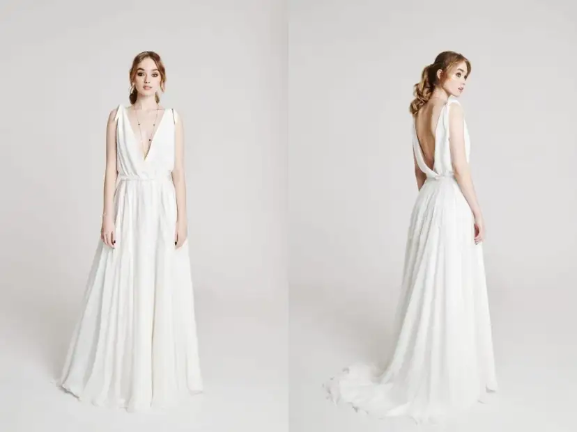 Elegancka, biała suknia ślubna z głębokim dekoltem i odkrytymi plecami. Zastanawiasz się, ile kosztuje uszycie sukni ślubnej?