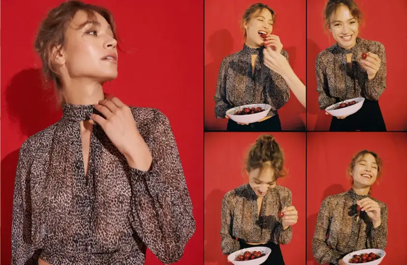 Kobieta w panterkowej bluzce z wiśniami. Zobacz, jak nosić panterkę w stylowy sposób, łącząc ją z czernią i soczystymi owocami.