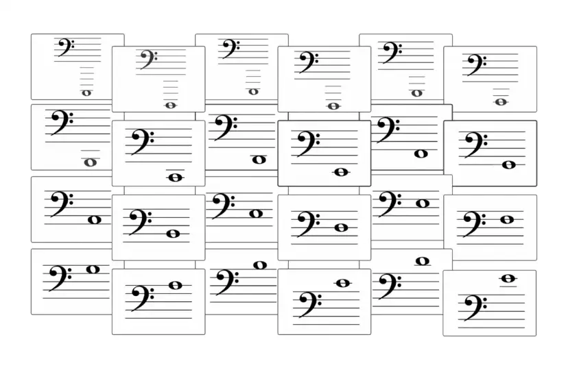 Wiele kart z pięciolinią i kluczem basowym, niektóre z nutami. Klucz basowy jest tu kluczowy.