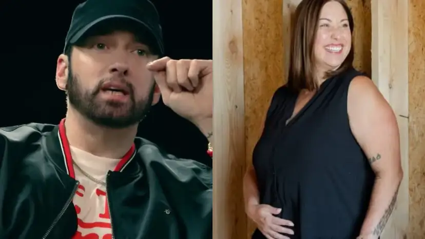 Eminem w czapce i czarnej kurtce obok uśmiechniętej kobiety w czarnej bluzce.