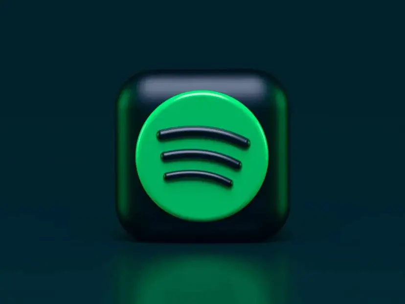 Ikona Spotify na ciemnozielonym tle.