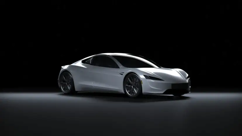 Srebrny Tesla Roadster na czarnym tle. Zastanawiasz się, ile kosztuje Tesla?