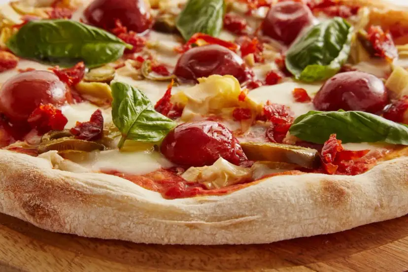 Pyszna pizza włoska z pomidorkami, mozzarellą i bazylią. Idealna na letni wieczór.