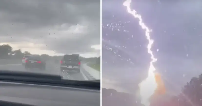 Samochody na drodze podczas burzy z piorunem na niebie.