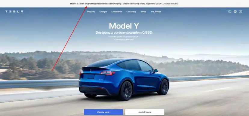 Niebieski Tesla Model Y na drodze. Czy ładowanie Tesli jest darmowe? Sprawdź warunki promocji na 1 rok darmowego ładowania Supercharging.