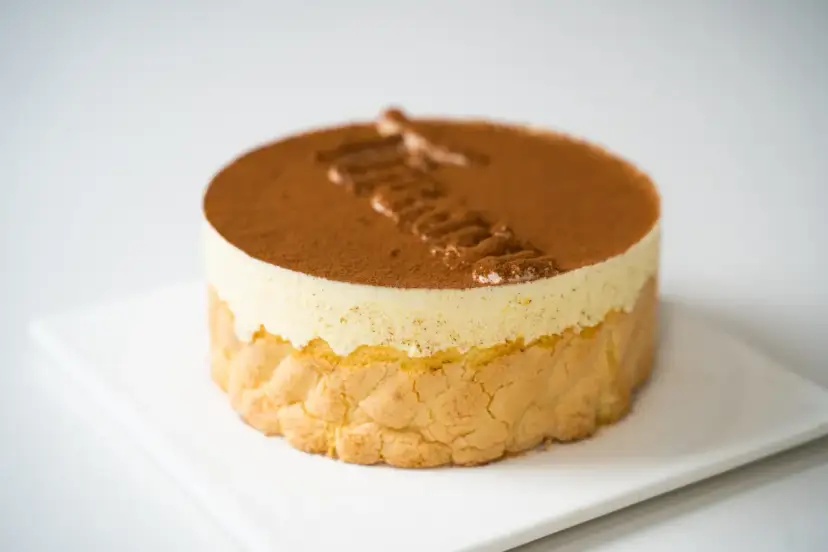 Pyszne tiramisu czekoladowe, udekorowane kakao i kremem. Idealne na deser.