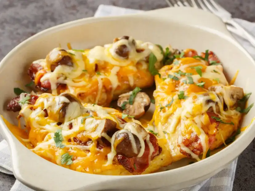 Pyszne piersi z kurczaka z patelni, zapieczone z bekonem, grzybami i ciągnącym się serem. Idealne danie dla całej rodziny.